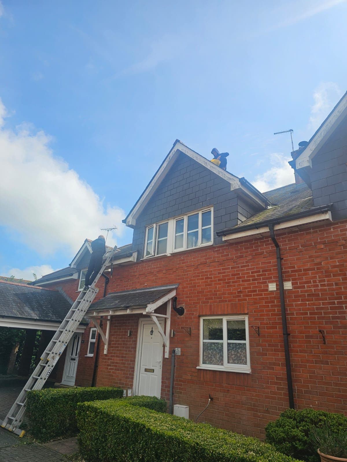 Roofers working on the roof of a house