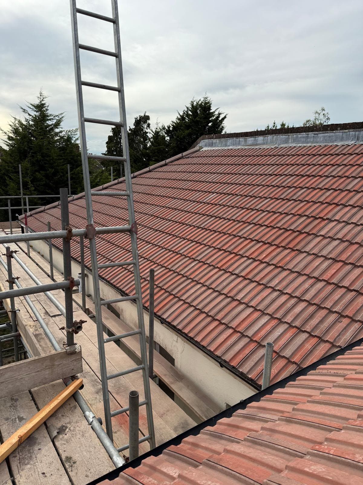 Red tiled roof beside scaffolding
